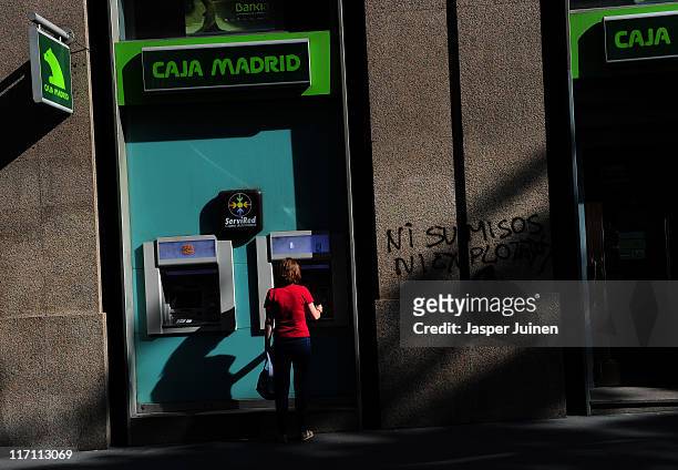 Woman uses a cash machine on June 22, 2011 in Madrid, Spain. Eurozone finance ministers are currently seeking to find a solution to Greece's pressing...