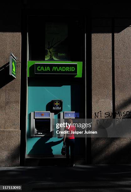 Woman uses a cash machine on June 22, 2011 in Madrid, Spain. Eurozone finance ministers are currently seeking to find a solution to Greece's pressing...