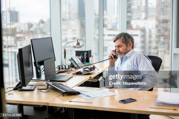 male business manager on a phone call using the landline office - landline phone stock pictures, royalty-free photos & images