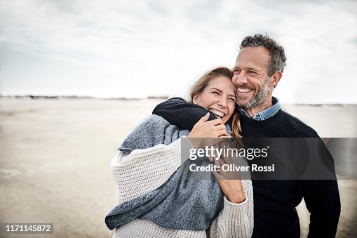 Happy couple hugging on the beach Happy couple hugging on the beach