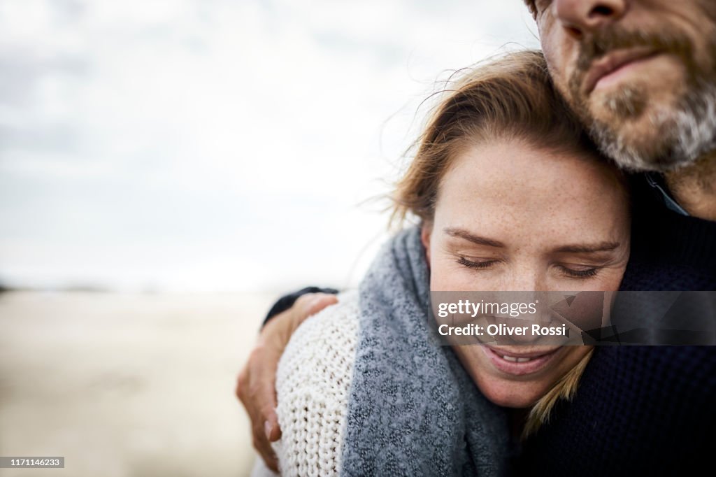 Affectionate couple hugging on the beach