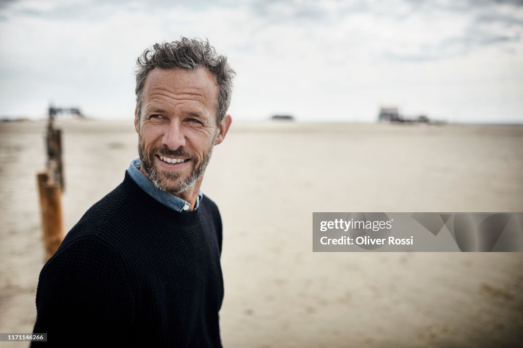 Portrait of smiling bearded man on the beach