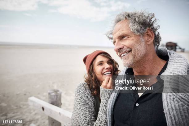 happy father with adult daughter on the beach - mature men laughing stock pictures, royalty-free photos & images