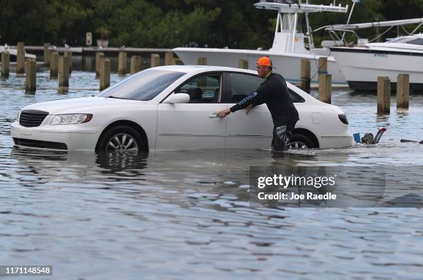 Weston Rice drives through a flooded parking lot as he prepares to drop his jet ski into the water at the Haulover Marine Center before the arrival...