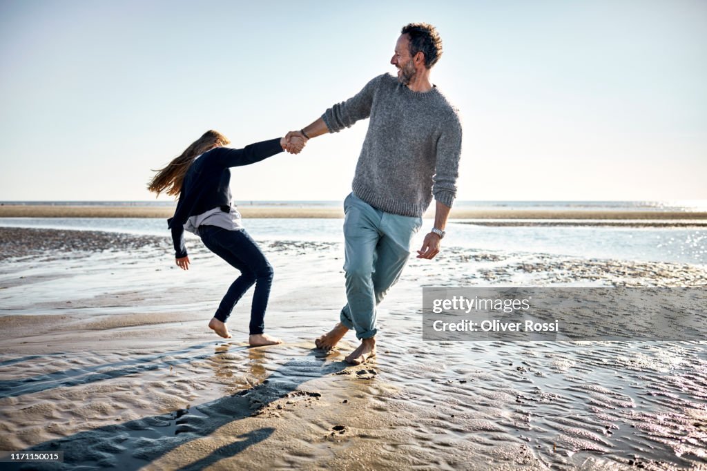 Happy father and daughter on the beach