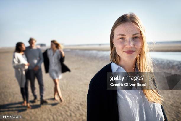portrait of smiling mature young woman on the beach - old man young woman stock-fotos und bilder