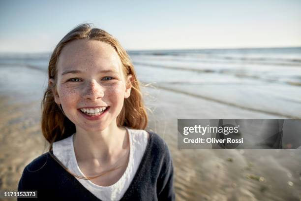 portrait of happy girl on the beach - pure joy stock pictures, royalty-free photos & images