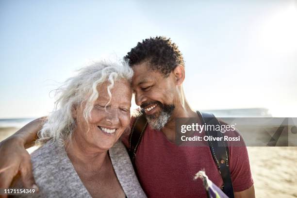 happy senior woman and mature man embracing - mutterliebe erwachsener sohn stock-fotos und bilder