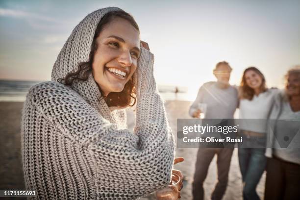 portrait of happy woman on the beach at sunset - mid twenties fun stock pictures, royalty-free photos & images