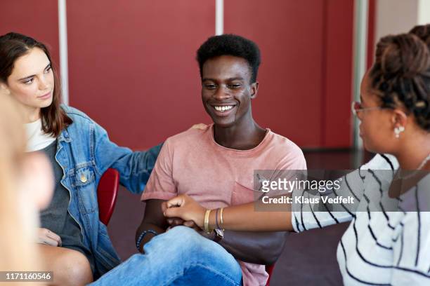 young female friends encouraging depressed man - african american man depressed bildbanksfoton och bilder