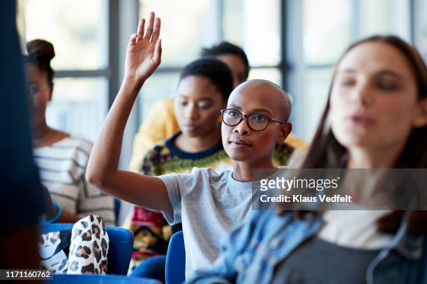 confident bald female student with arms raised - participant stock-fotos und bilder