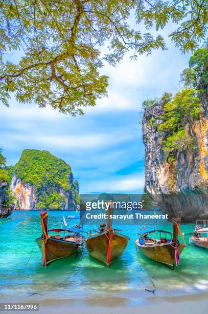 women wearing a hat to sit on the island of koh lao laing krabi thailand - railay strand stock pictures, royalty-free photos & images