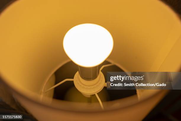 Close-up of a Philips Hue web-connected smart lightbulb installed in a light fixture in a smart home in San Ramon, California, August 29, 2019.