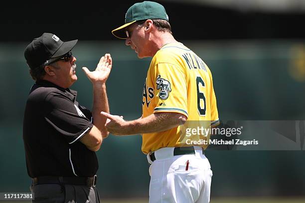 Manager Bob Melvin of the Oakland Athletics argues with umpire Tim Tschida after getting tossed from the game against the Kansas City Royals at the...