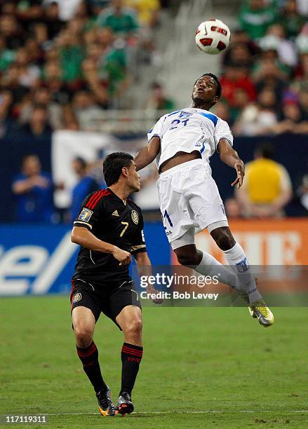 Juan Carlos Garcia of Honduras goes up for a header over Pablo Barrera of Mexico in the second half at Reliant Stadium on June 22, 2011 in Houston,...