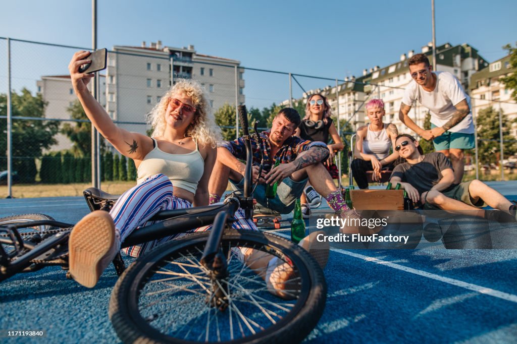 Alternative people doing selfies on a social gathering