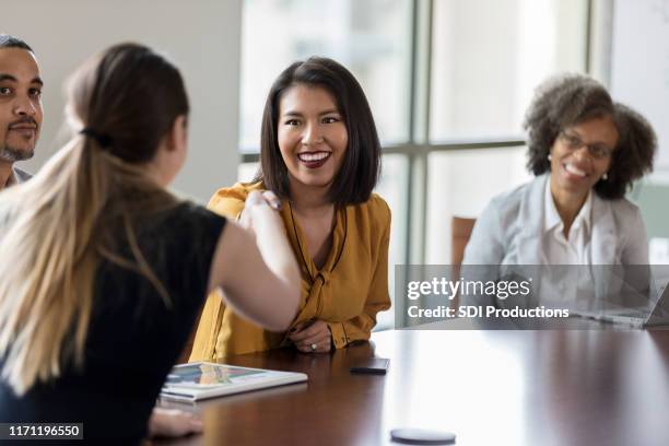 businesspeople greet one another - boardmember stock pictures, royalty-free photos & images