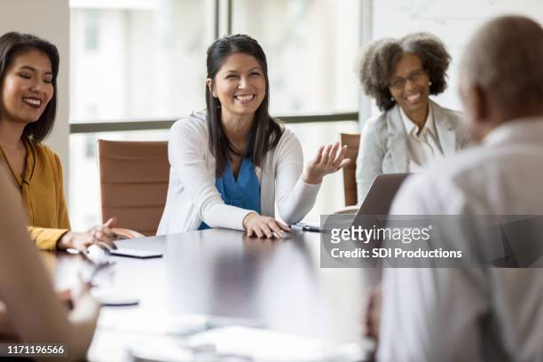 woman facilitating business meeting - boardmember stock pictures, royalty-free photos & images