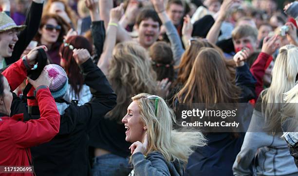 Festival goers dance as they gather at the Stone Circle to see the sun set at the Glastonbury Festival site at Worthy Farm, Pilton on June 22, 2011...