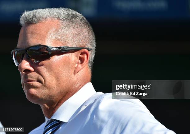 General manager Dayton Moore of the Kansas City Royals watches batting practice prior to a game against the Baltimore Orioles at Kauffman Stadium on...