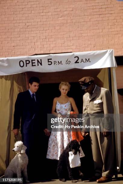 General view as a couple gets their dogs from the attendant before leaving the Fairchild's Restaurant and Dog Lounge circa April, 1953 in New York.