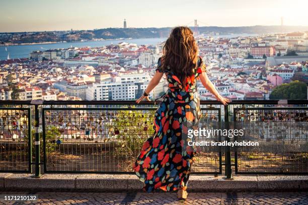 woman enjoying view from miradouro da senhora do monte in lisbon, portugal - lisbon stock pictures, royalty-free photos & images