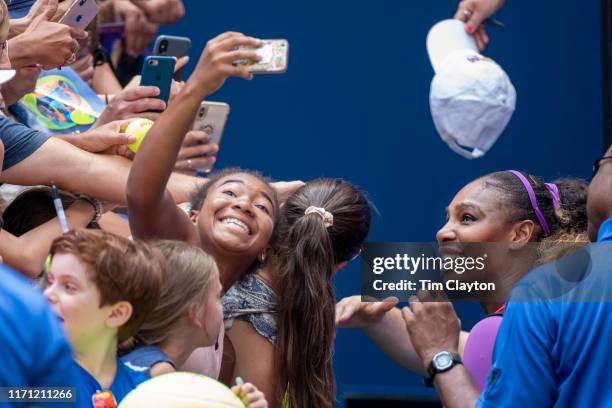 Open Tennis Tournament- Day Five. A young fan takes a selfie with Serena Williams of the United States as she signs autographs after her win against...