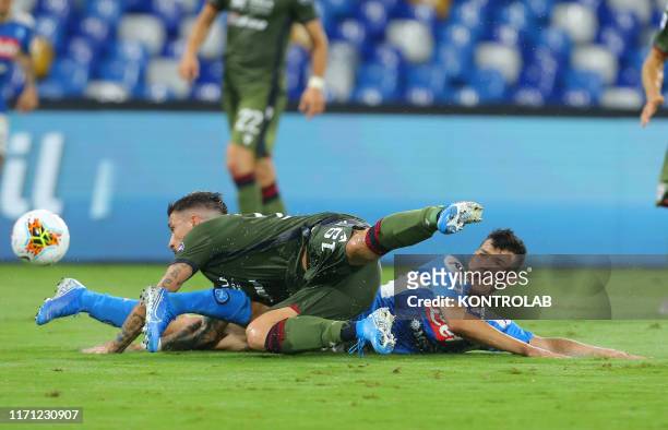 Napoli's Mexican forward Hirving Lozano fights for the ball with Cagliari's Italian defender Fabio Pisacane during the Italian Serie A football match...