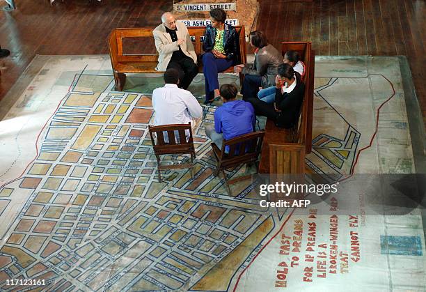 First lady Michelle Obama listens to Ahmed Kathrada , former political prisoner on Robben Island and anti-apartheid figure, as she visits the...