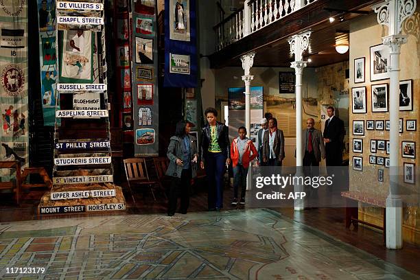 First lady Michelle Obama walks with daughter Sasha as she visits the District Six museum, in Cape Town, South Africa, June 23, 2011. Founded in 1867...