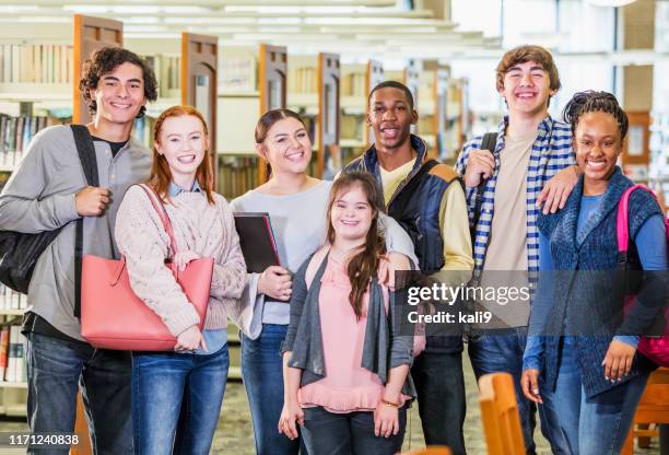 high school students in library, girl with down syndrome - learning disabilities stock pictures, royalty-free photos & images