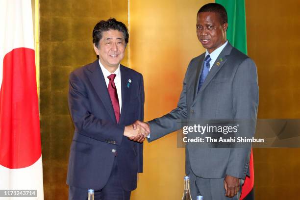 Zambia President Edgar Lungu and Japanese Prime Minister Shinzo Abe shake hands prior to their bilateral meeting on the sidelines of the Seventh...