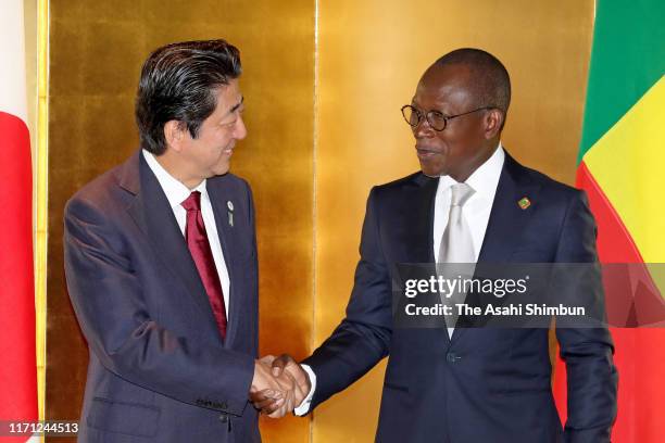 Benin President Patrice Talon and Japanese Prime Minister Shinzo Abe shake hands prior to their bilateral meeting on the sidelines of the Seventh...