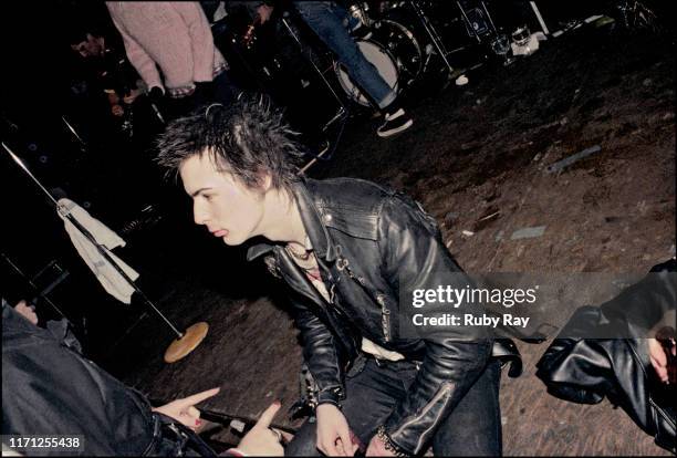 British musician Sid Vicious , the day after the Sex Pistols had split up, is urged to calm down as he sits on the stage floor at Mabuhay Gardens in...