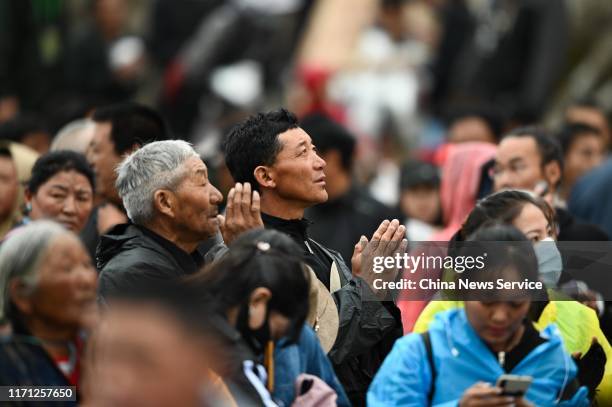 Pilgrims worship a giant thangka during the Sho Dun Festival at Drepung Monastery on August 30, 2019 in Lhasa, Tibet Autonomous Region of China.