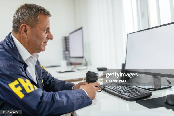 Fbi Typing At Computer 562 Security Officer On Computer Stock Photos, High-Res Pictures, and ...
