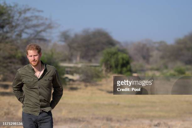Prince Harry, Duke of Sussex during a tree planting event with local schoolchildren, at the Chobe Tree Reserve, Botswanaon day four of their tour of...