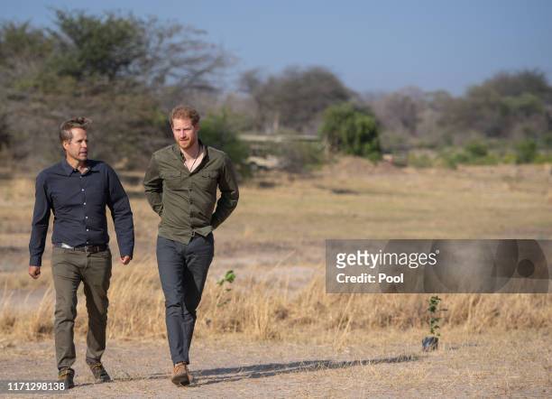 Prince Harry, Duke of Sussex with founder of Elephants Without Borders Dr Mike Chase, during a tree planting event with local schoolchildren at the...