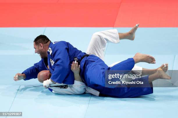 Rafael Silva of Brazil throws Henk Grol of the Netherlands in the Men's +100kg Repechage on day seven of the World Judo Championships at the Nippon...