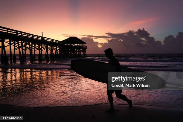 Surfer Scott Norwood prepares to go in the water as Hurricane Dorian approaches Florida, on August 31, 2019 in Cocoa Beach, Florida. Dorian could be...