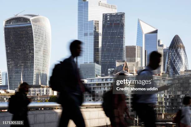 london city workers against high rise office buildings - zona financiera fotografías e imágenes de stock