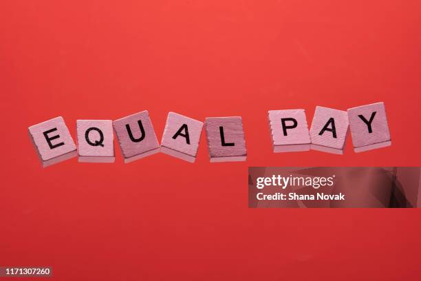 pink game squares spell equal pay - equal pay day bildbanksfoton och bilder