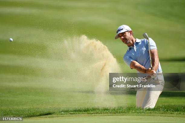 Wade Ormsby of Australia plays a bunker shot on the first hole during Day three of the Omega European Masters at Crans Montana Golf Club on August...