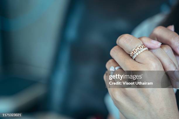 close up of an elegant engagement diamond ring on beautiful asian woman's finger - リング ストックフォトと画像