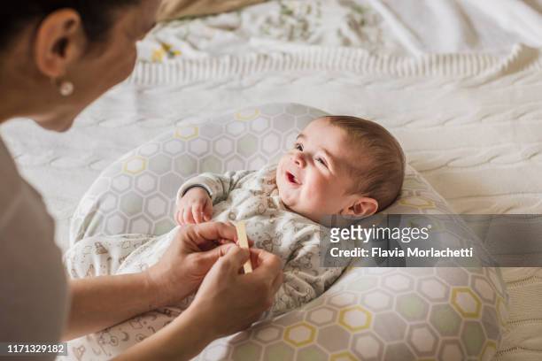 Mother filing her baby boy nails