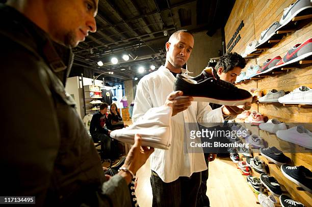 Ariel Perez, left, Ivan Llanez, center and Yosmel Montejo of Cuba shop for shoes at the Nike Inc.'s Niketown store in downtown San Francisco,...