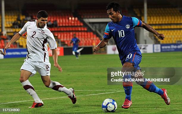 Murad Naji K Hussein of Qatar looks on as Jeje Lalpekhlua of India attempts a shot at goal during the second leg of their 2012 London Olympic Asian...