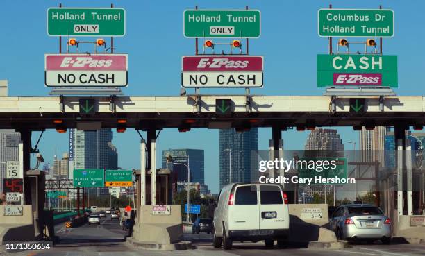 Cars pass through a toll plaza on the New Jersey Turnpike on August 29, 2019 in Jersey City, New Jersey.