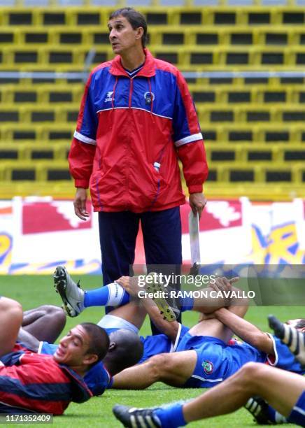 Head coach of the Costa Rican soccer team, Alexander Guimaraes , watches the players as they warm-up for practice at the Azteca Stadium, in Mexico...