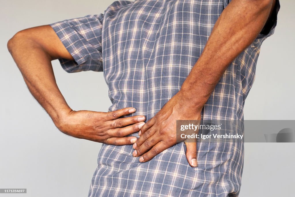Elderly african man, pain at lower back.
